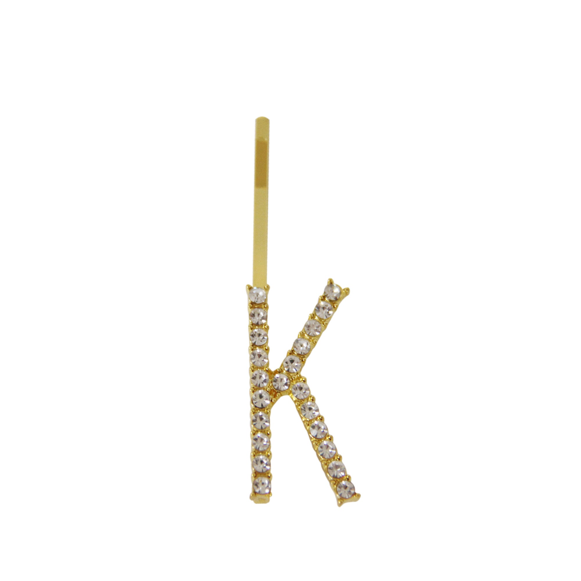 Gold and crystal letter 'K' hair slide on a white background