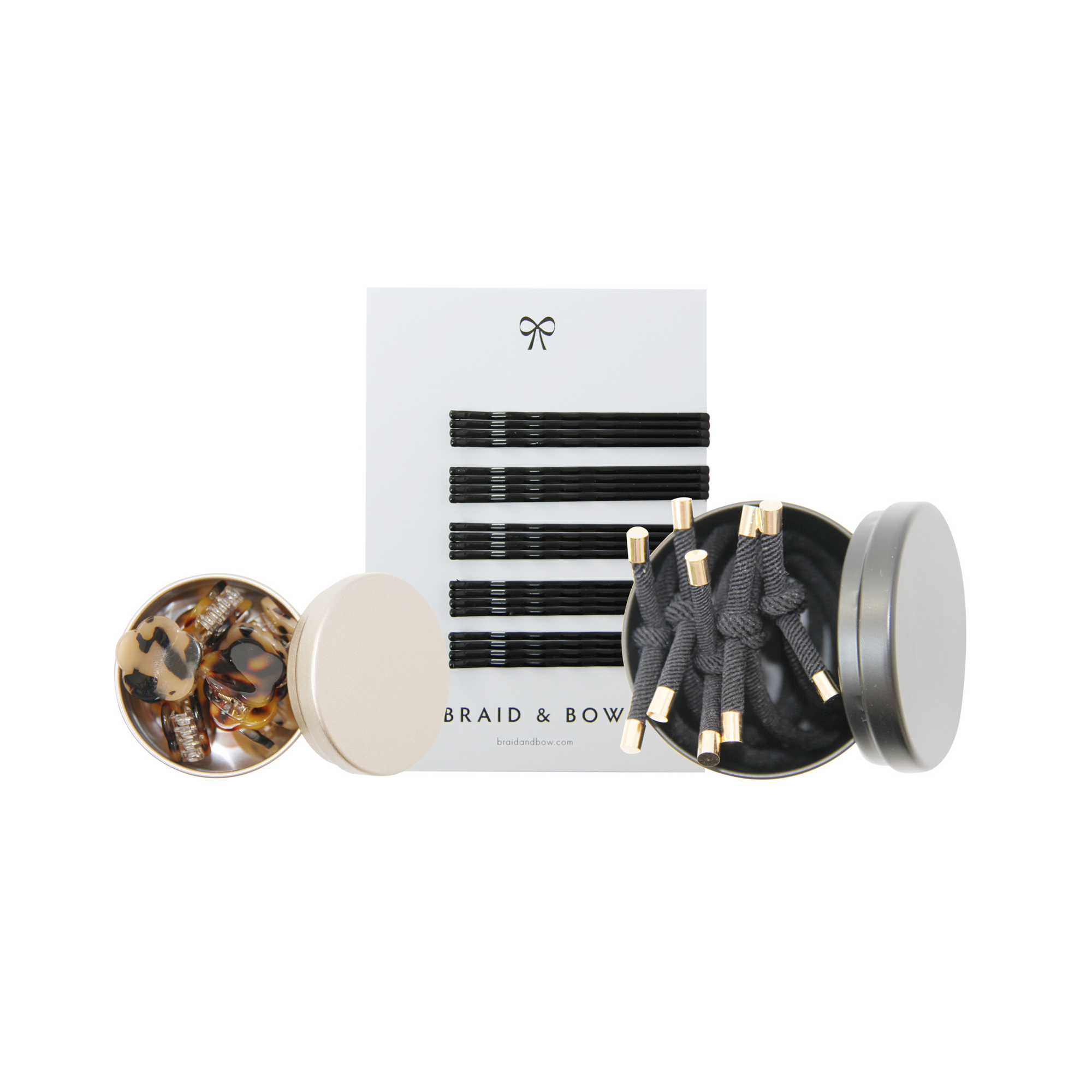 Set of hair accessories including hair ties, hair claws and set of black kirby grips on a white background