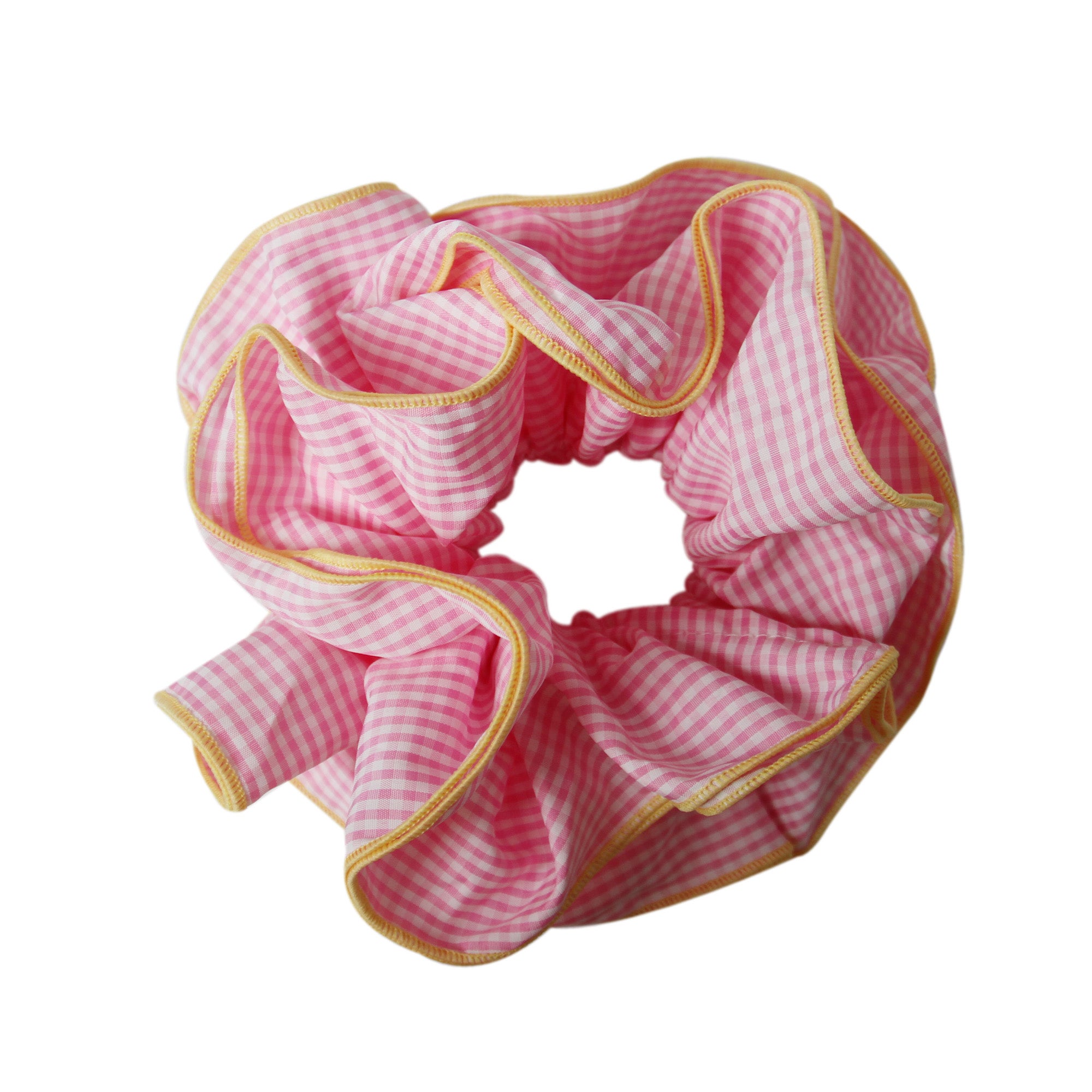 Pink gingham scrunchie with a yellow trim on a white background