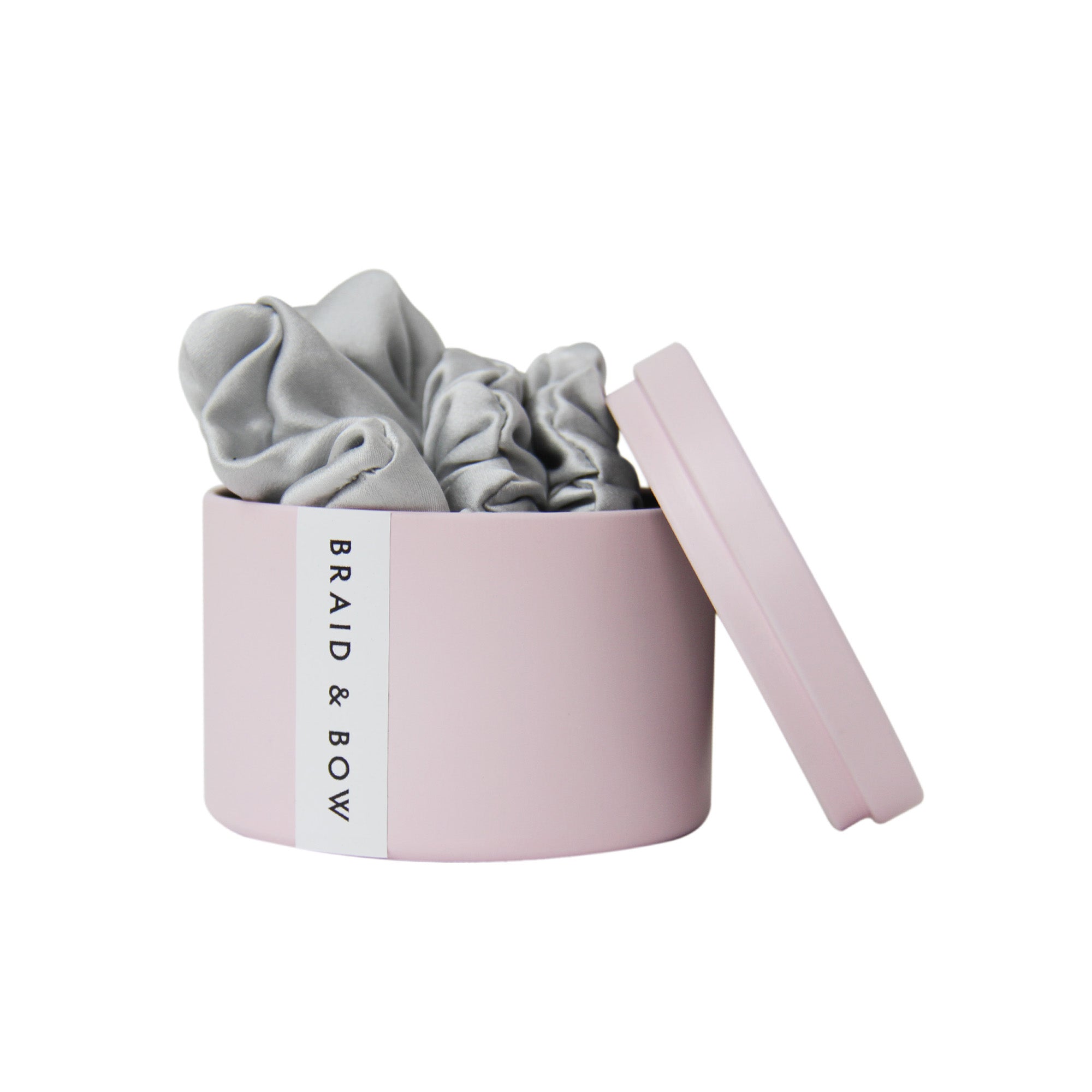 Pink Braid & Bow tin with three silver silk scrunches on a white background