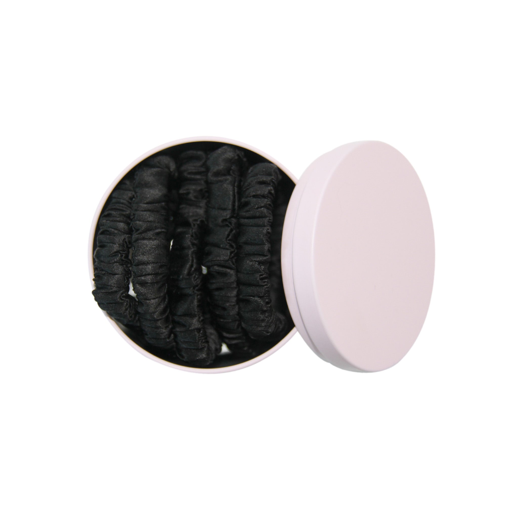 Set of 5 black silk hair ties in a pink tin on a white background