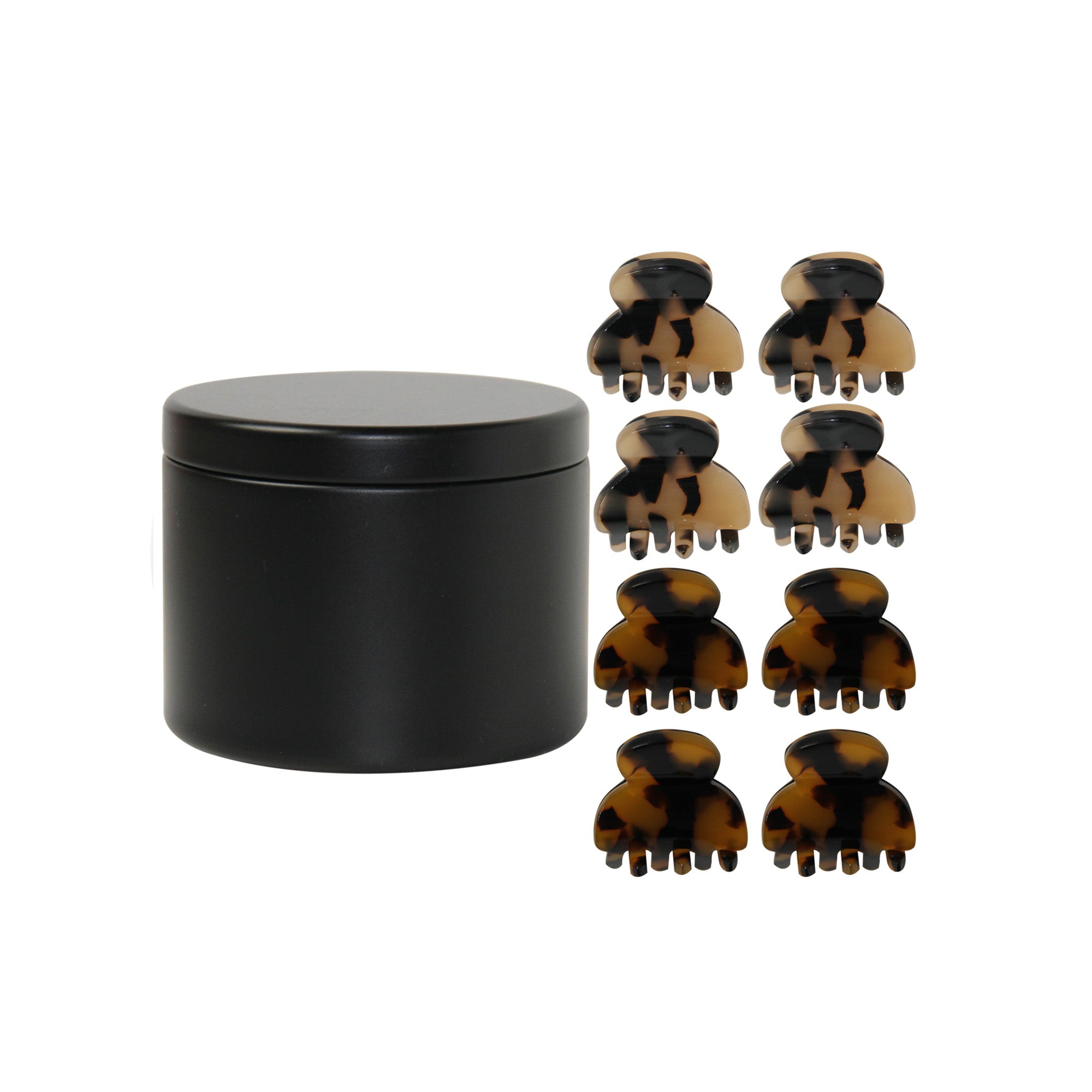 set of 8 mini tortoiseshell hair claws next to the black tin they come in on a white background