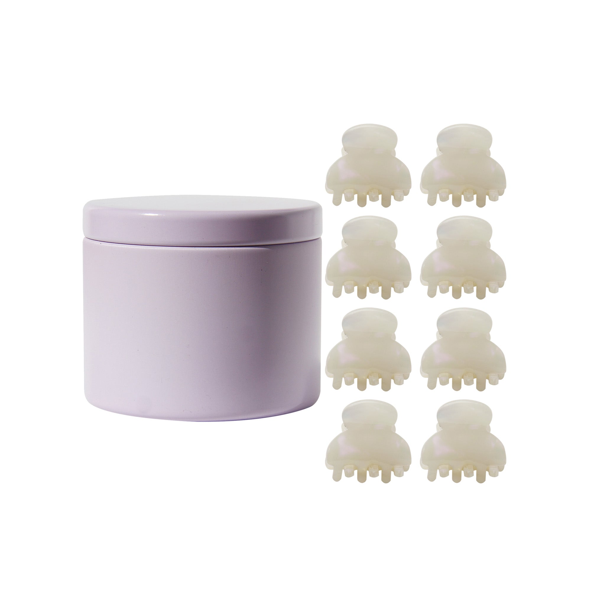 set of 8 mini pearlised hair claws next to the purple tin they come in on a white background