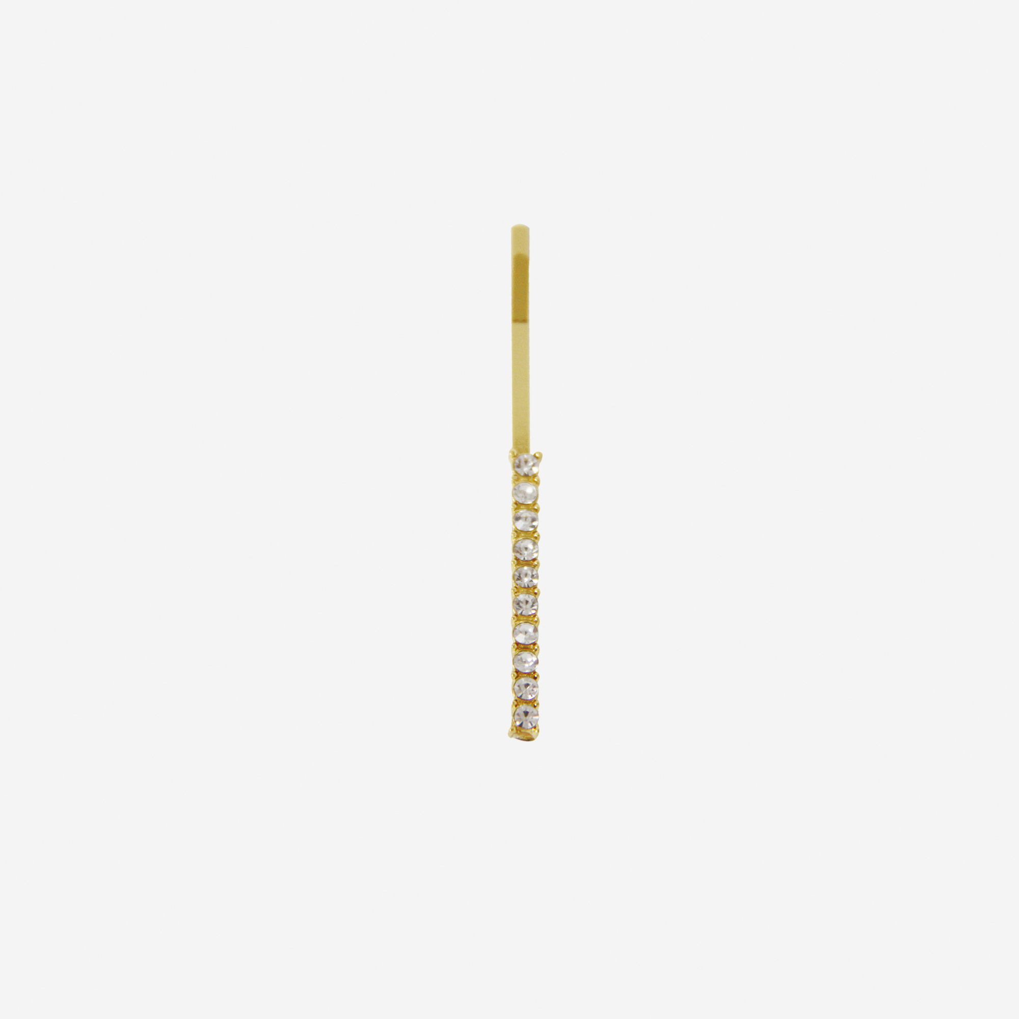 Gold and crystal hair slide featuring the letter 'I' on an off white background