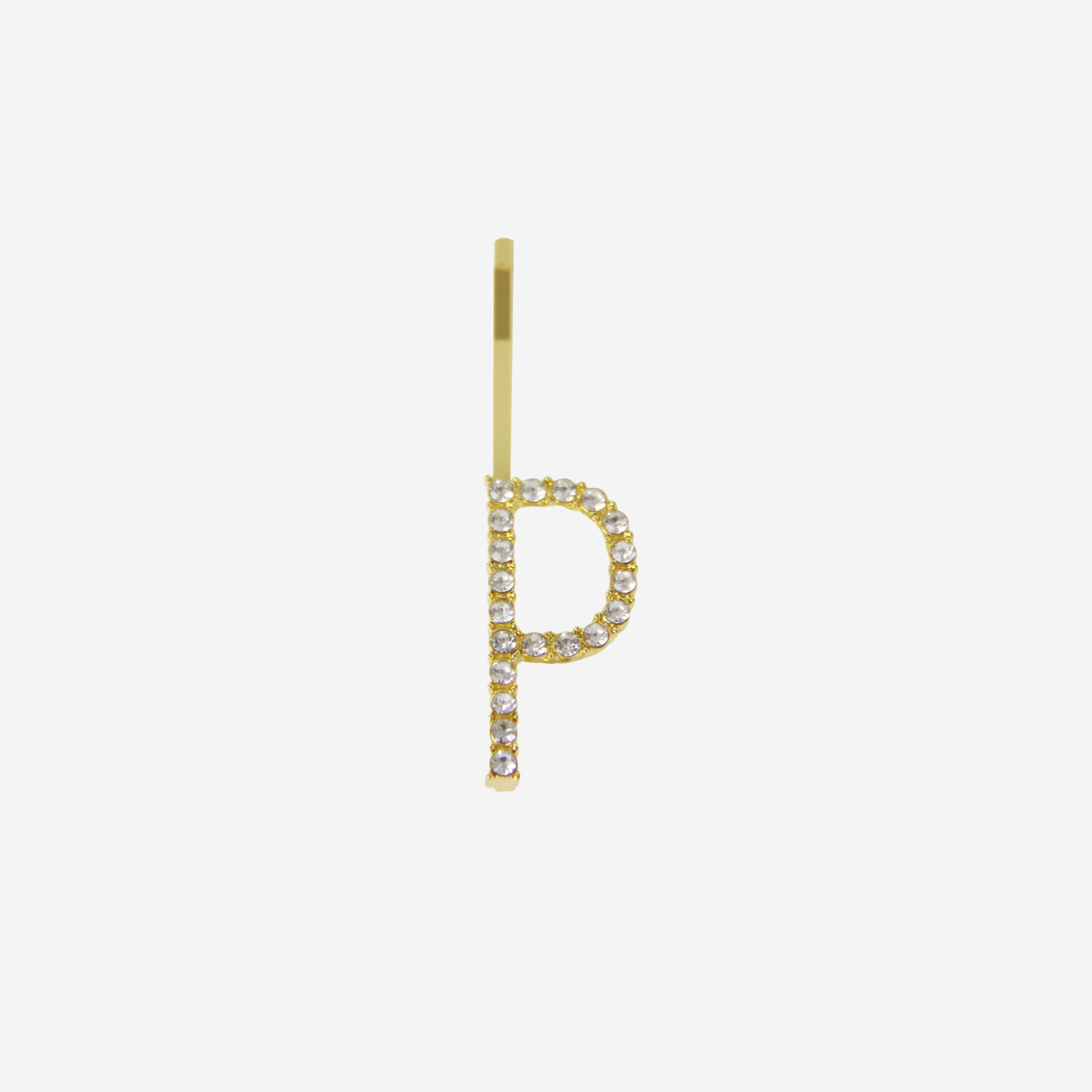 Gold and crystal hair slide featuring the letter 'P' on an off white background