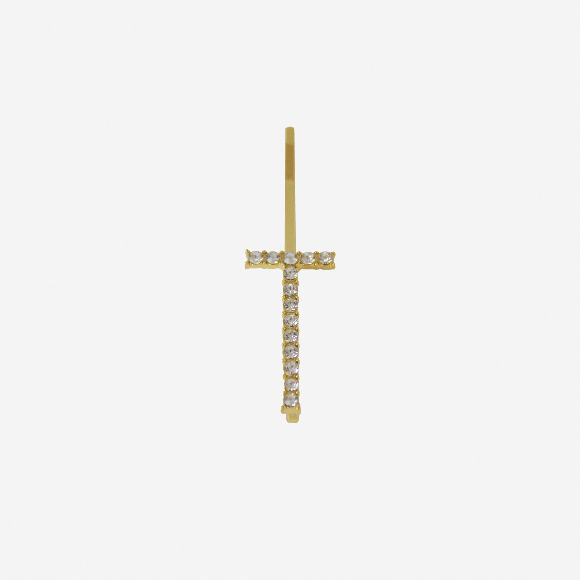 Gold and crystal hair slide featuring the letter 'T' on an off white background
