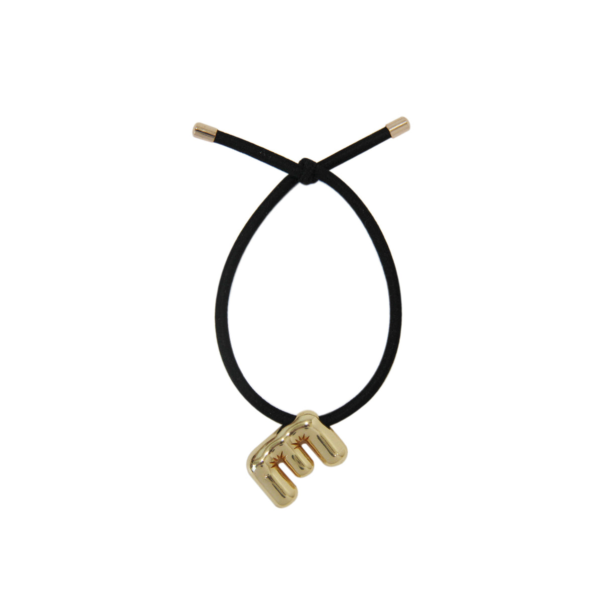 Black hair tie with gold letter 'E' charm on a white background