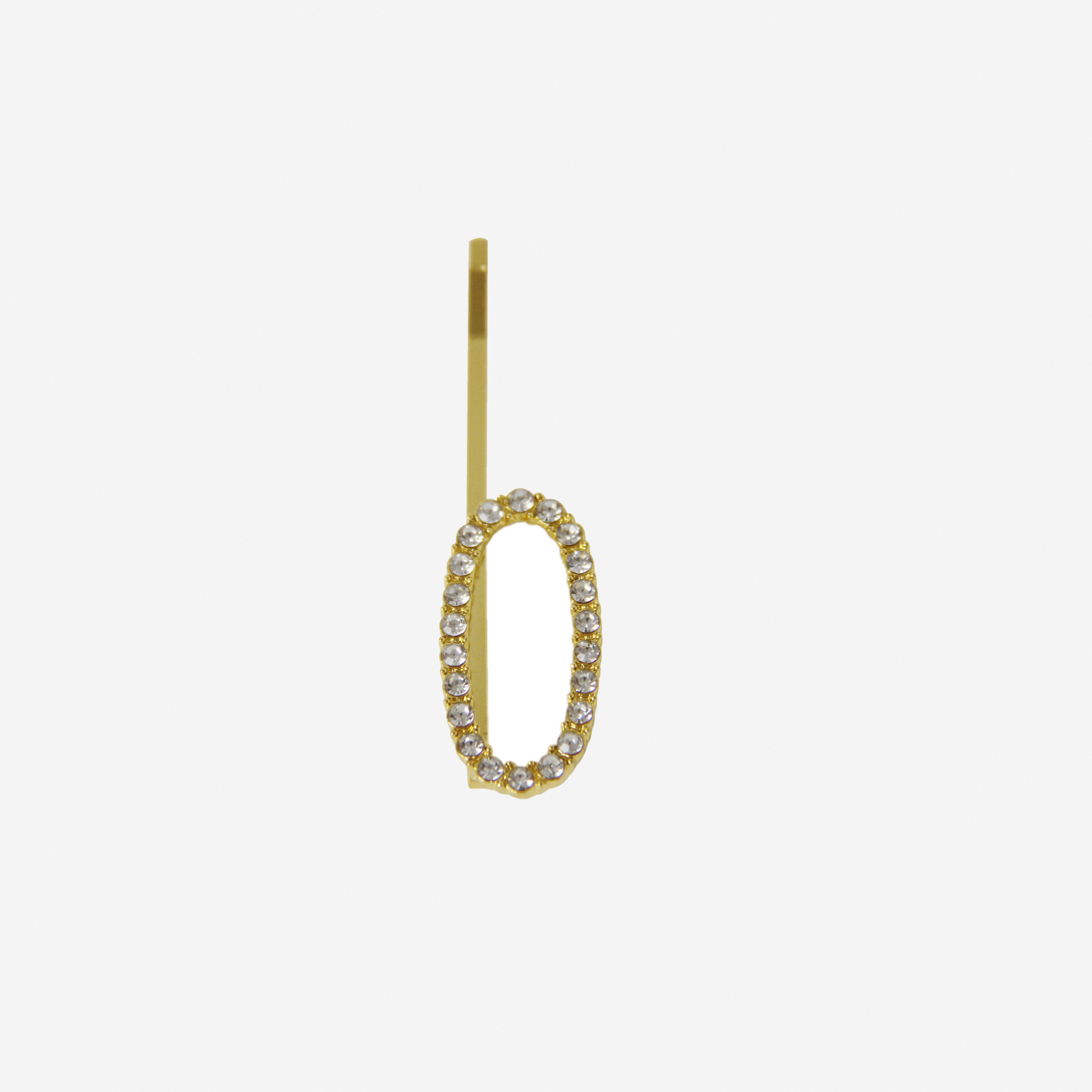 Gold and crystal hair slide featuring the letter 'O' on an off white background