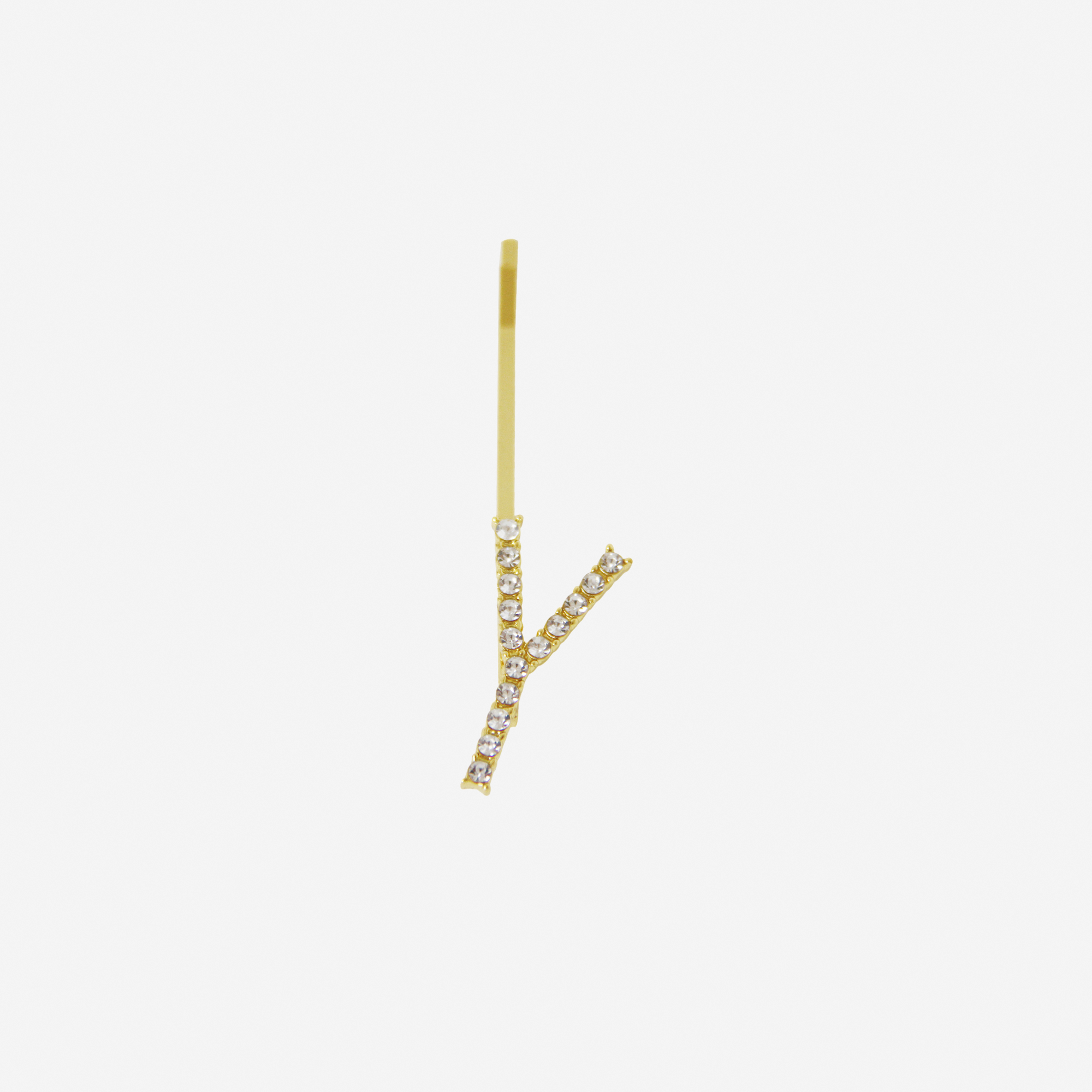 Gold and crystal hair slide featuring the letter 'Y' on an off white background