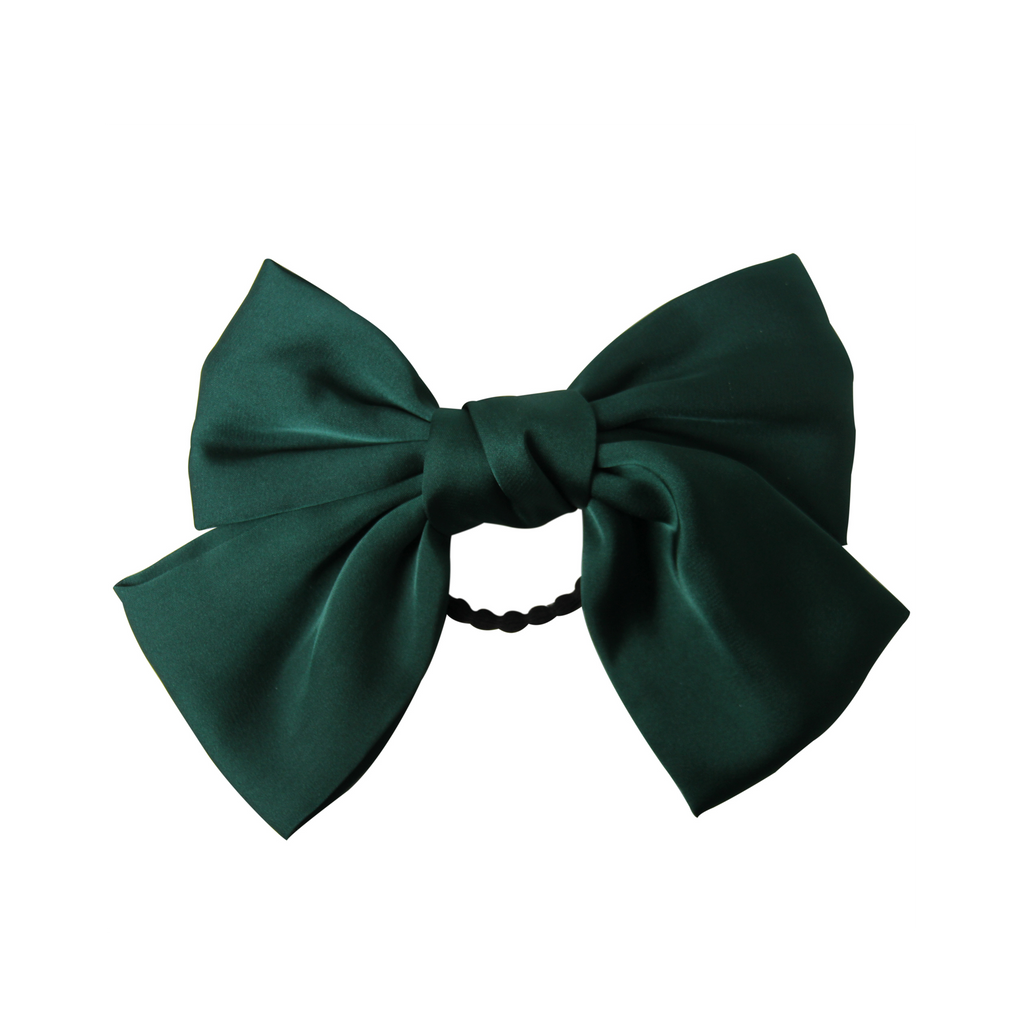 Green bow hair tie on a white background
