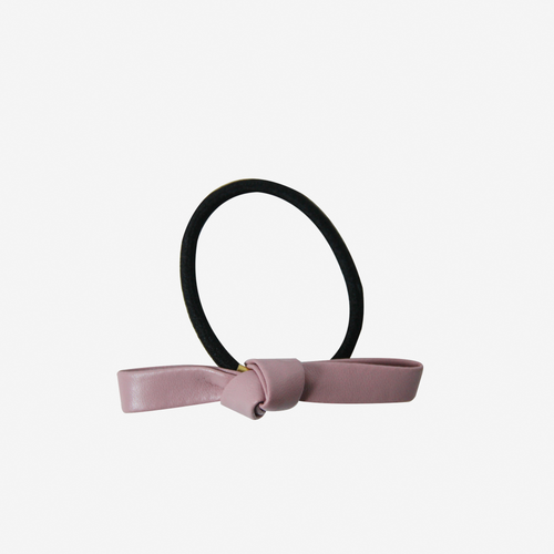 PInk faux leather bow on a black hair elastic