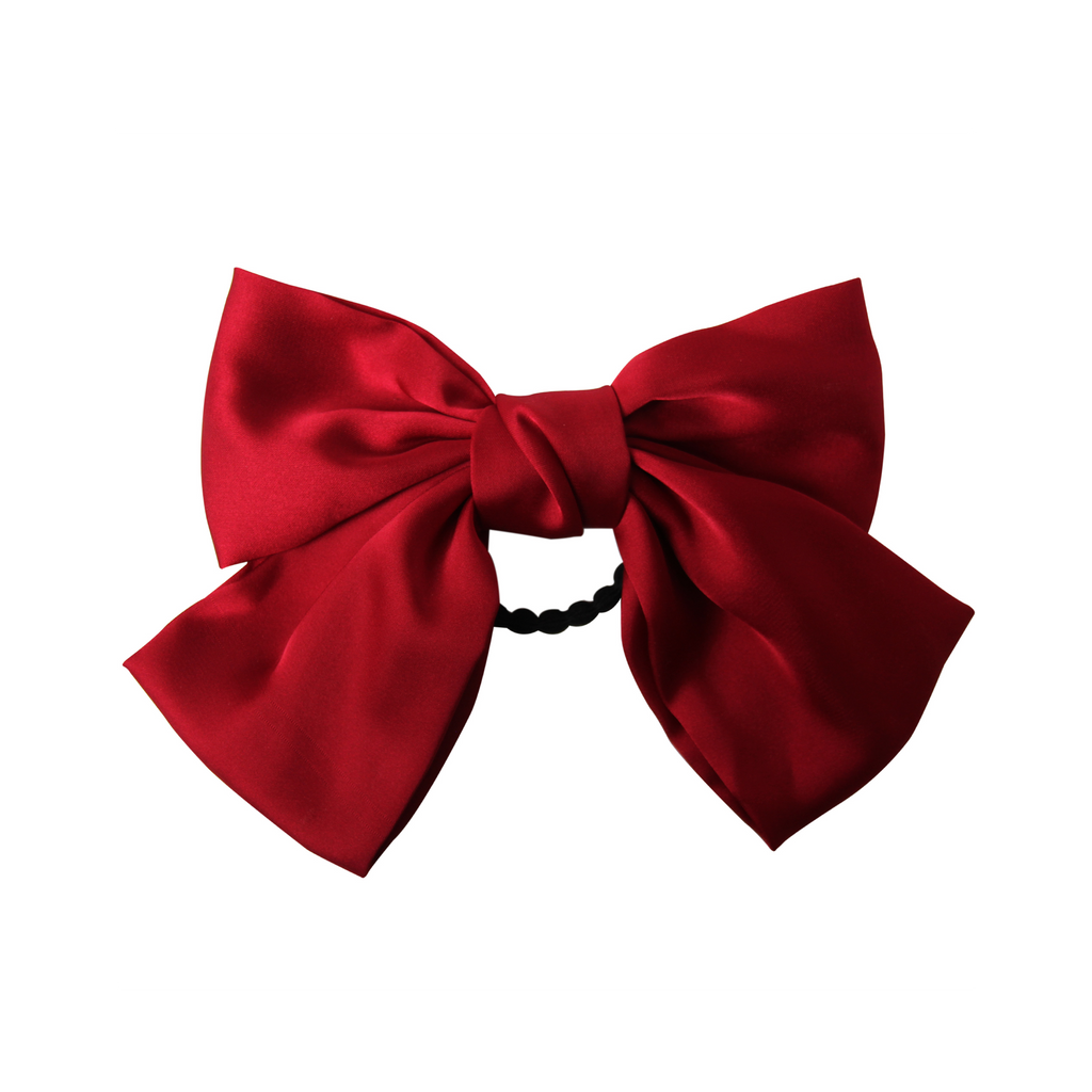 Red bow hair tie on a white background