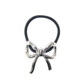 Silver bow-shaped hair tie on a white background