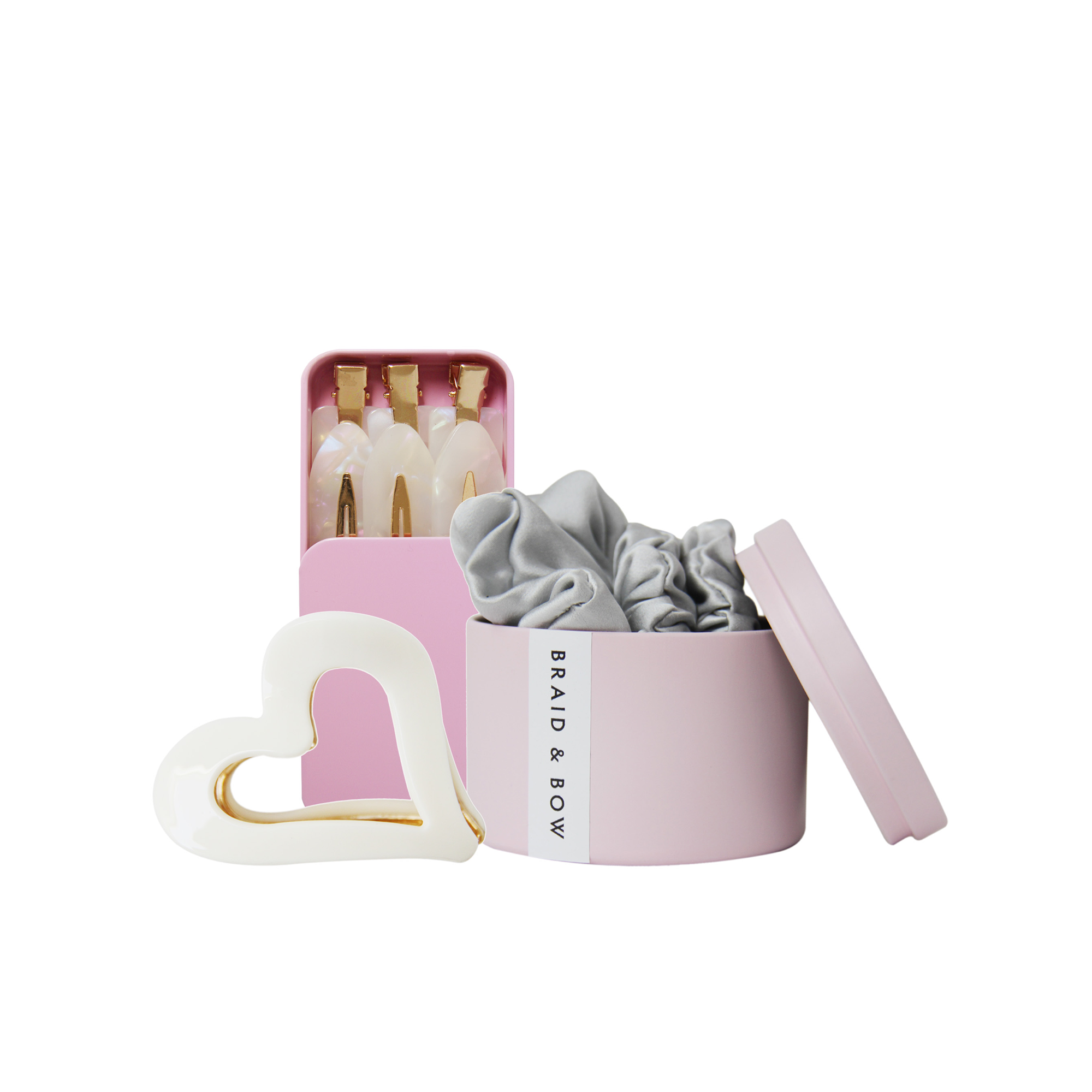 Set of hair accessories, showing  silver silk hair scrunchies, set of 6 non crease hair clips and cream heart hair claw on a white background