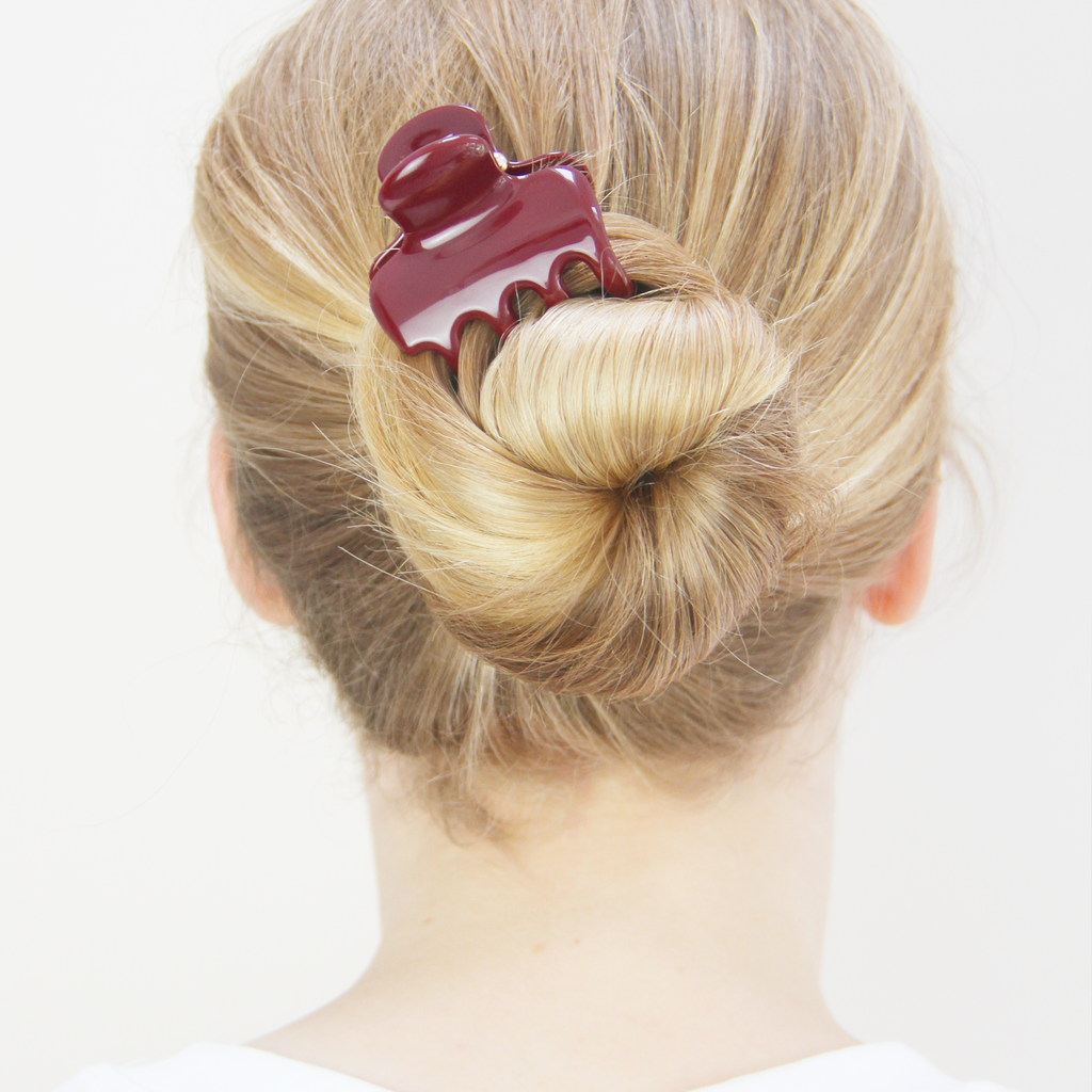  Medium burgundy hair claw securing a blonde bun in place