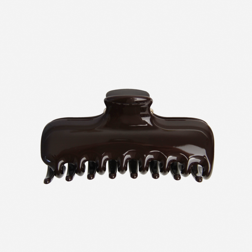 Large chocolate brown hair claw on an off white background