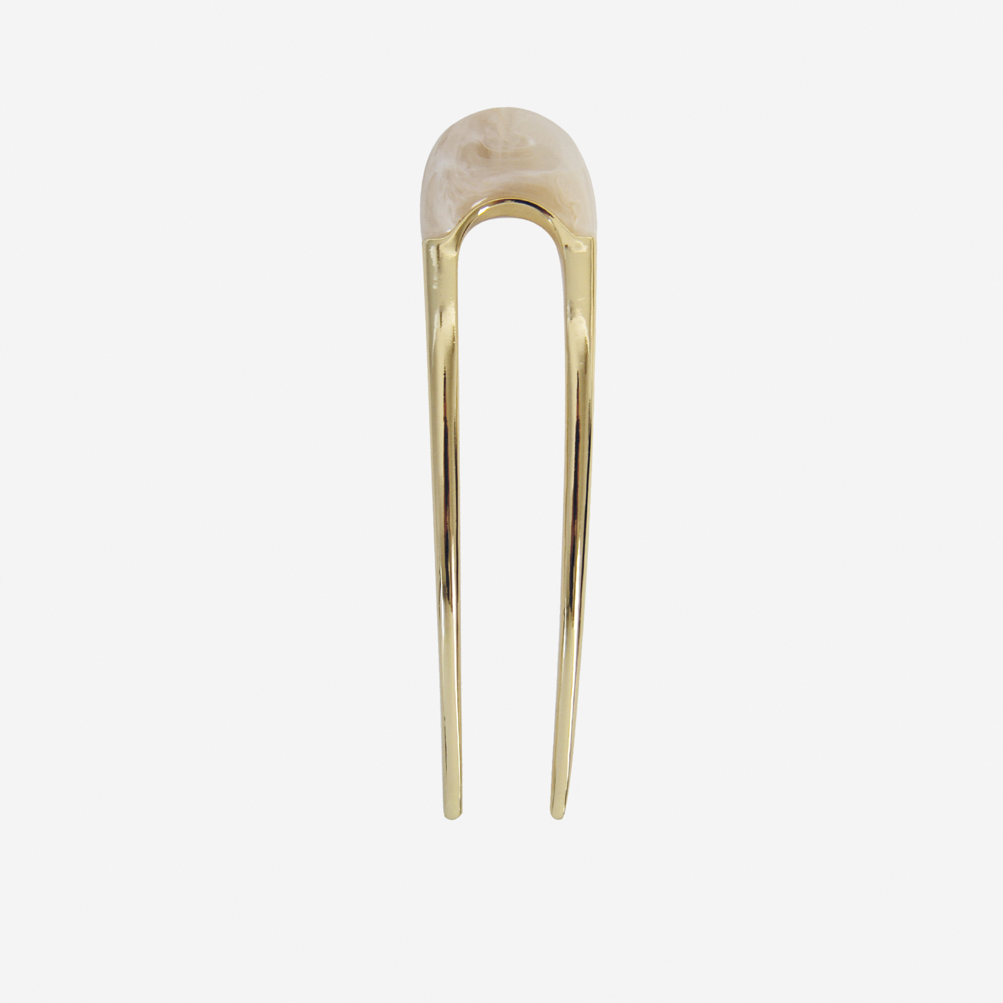 Gold hair pin with a cream resin detail on the top on an off white background