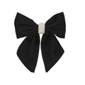 Black hair bow with a crystal pave center on a white background