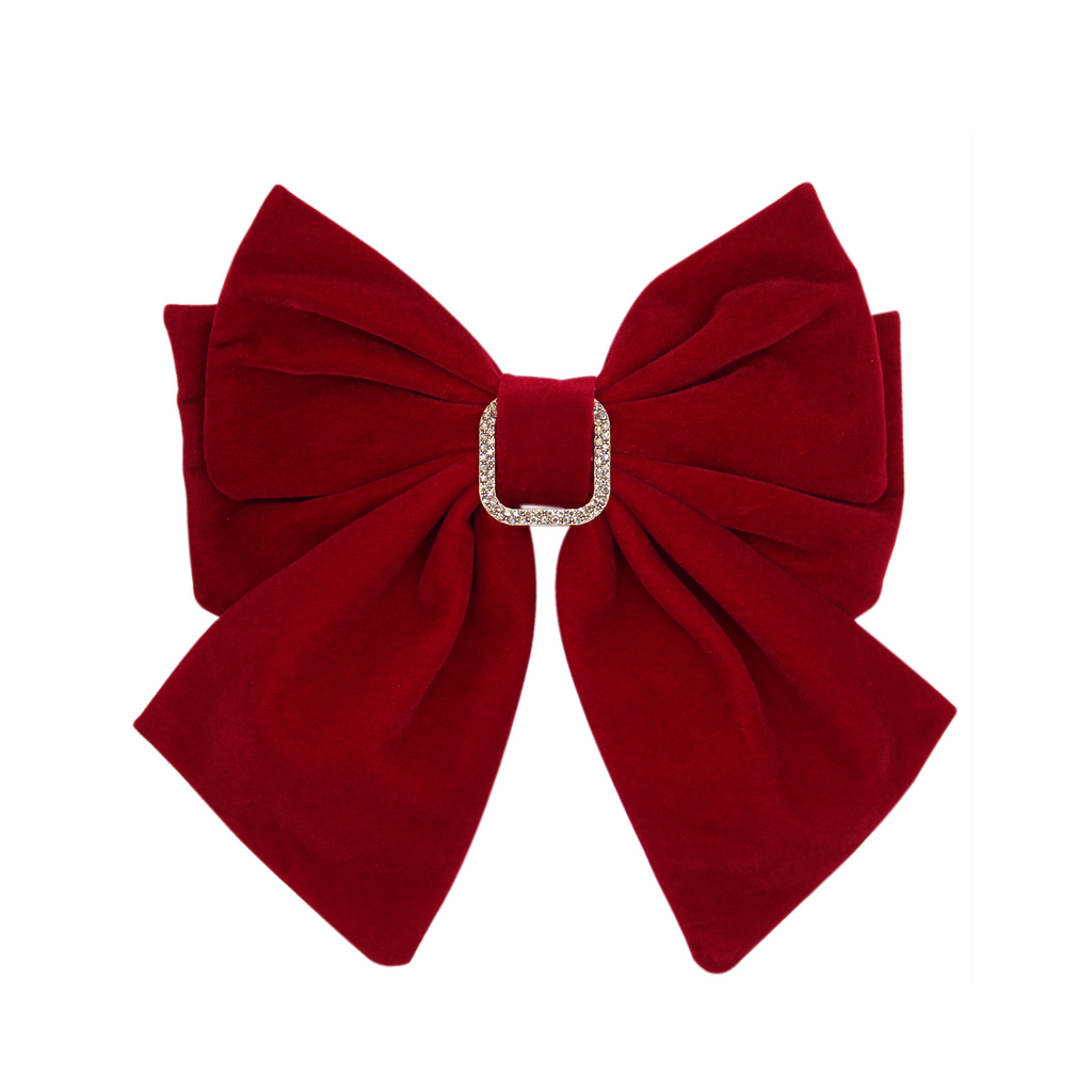 Red velvet bow with a crystal detail on a white background