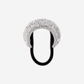 Silver crystal encrusted hair tie on an off white background