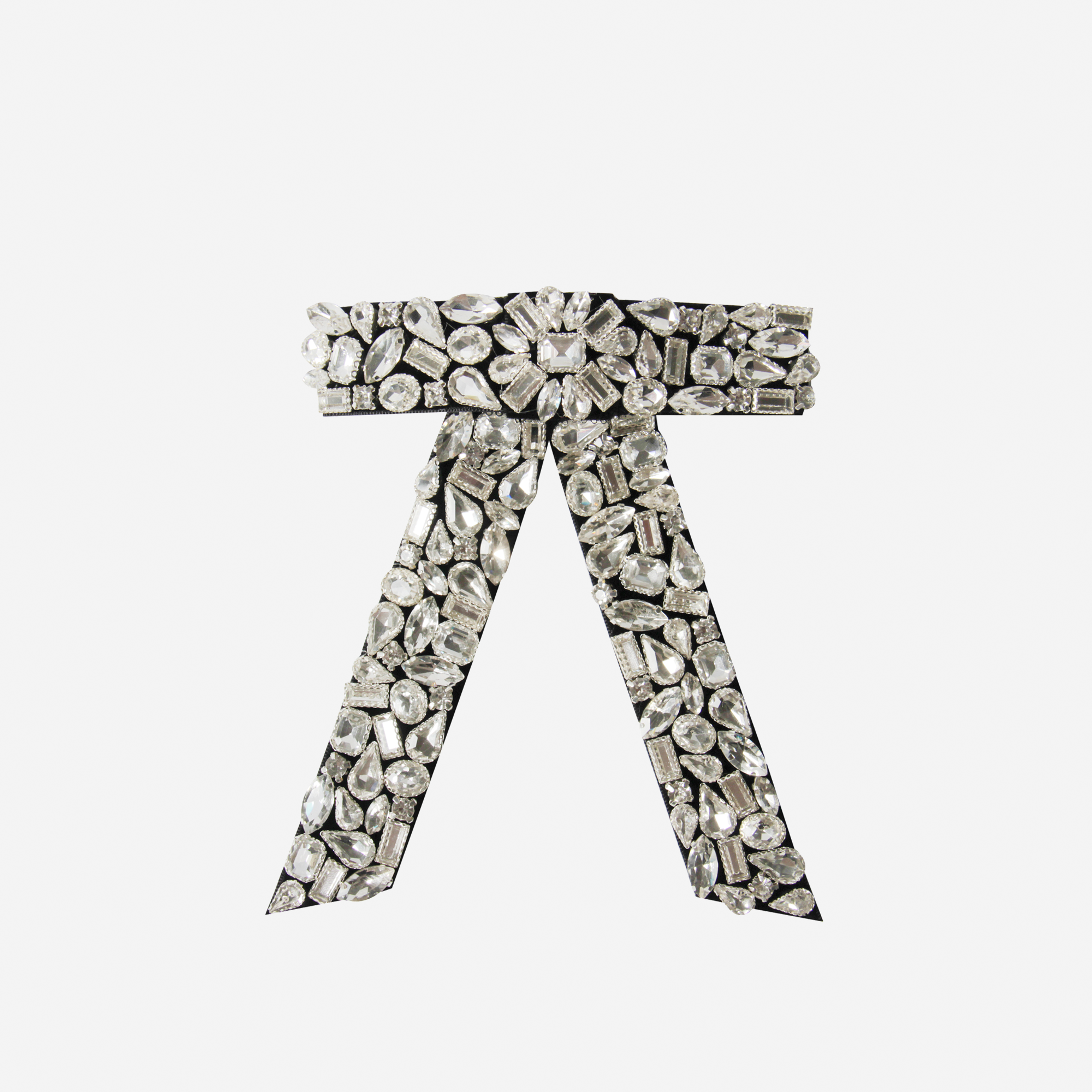 Crystal encrusted black velvet hair bow on an off white background