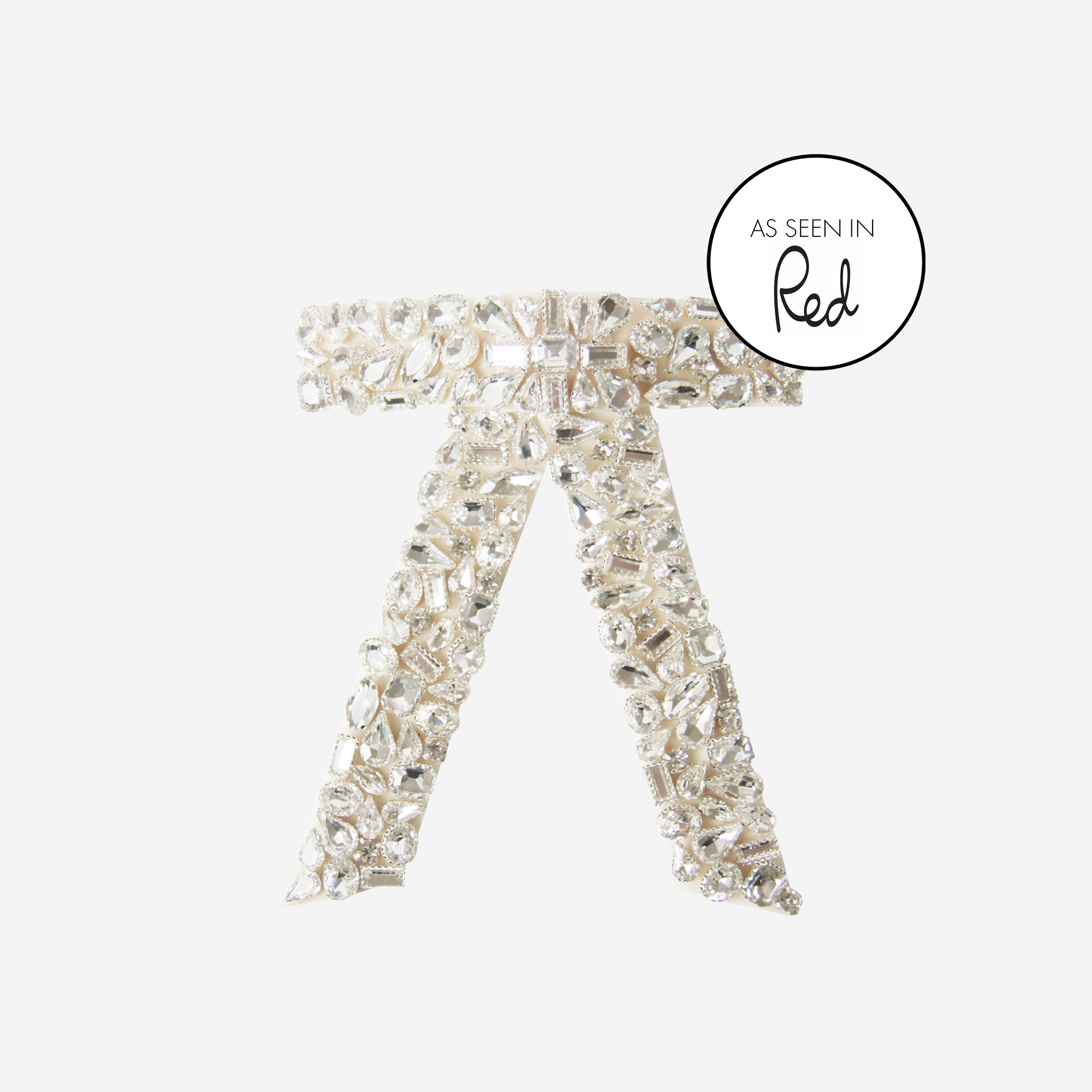 Crystal encrusted cream velvet hair bow on an off white background featuring an as seen in Red magazine logo