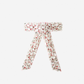 Crystal encrusted pink velvet hair bow on an off white background