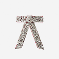 Crystal encrusted red velvet hair bow on an off white background