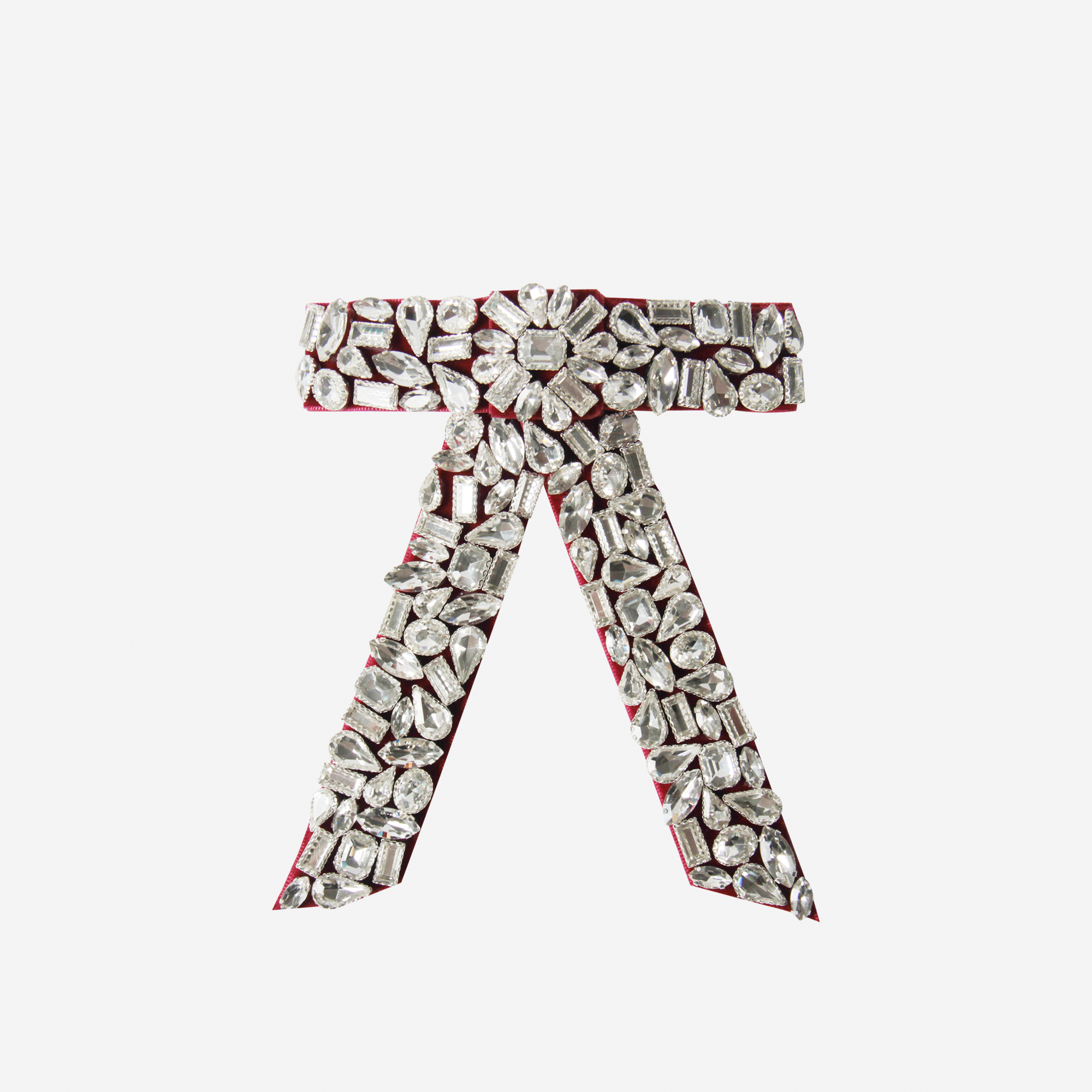 Crystal encrusted red velvet hair bow on an off white background