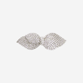 Crystal pave bow shaped hair clip on an off white background