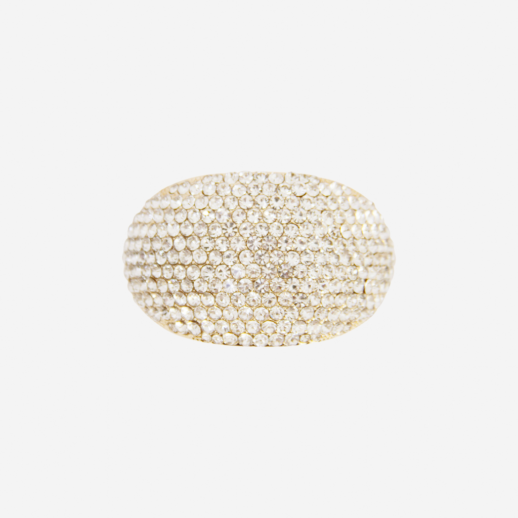 Oval Gold and crystal pave ponytail holder on an off white background