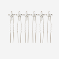 Set of 6 silver hairpins with crystal flower designs on an off white background