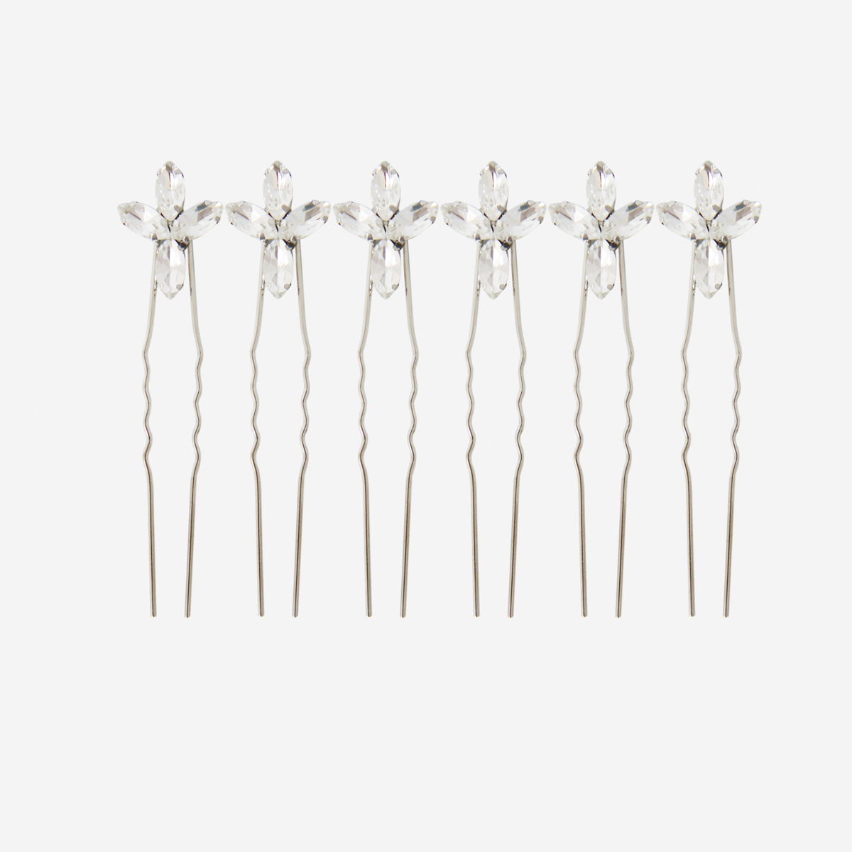 Set of 6 silver hairpins with crystal flower designs on an off white background