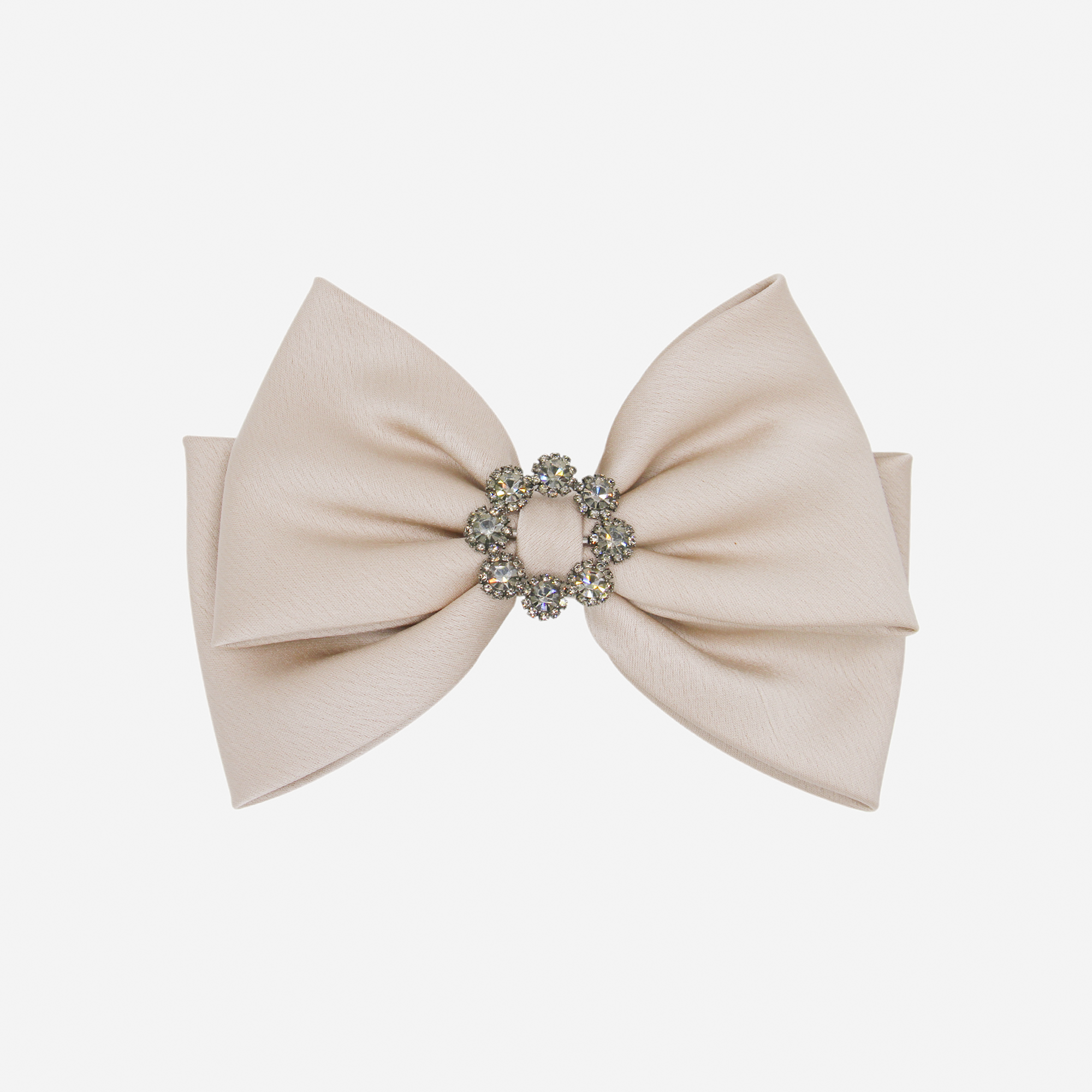 Taupe bow hair clip with a decorative crystal center on an off white background