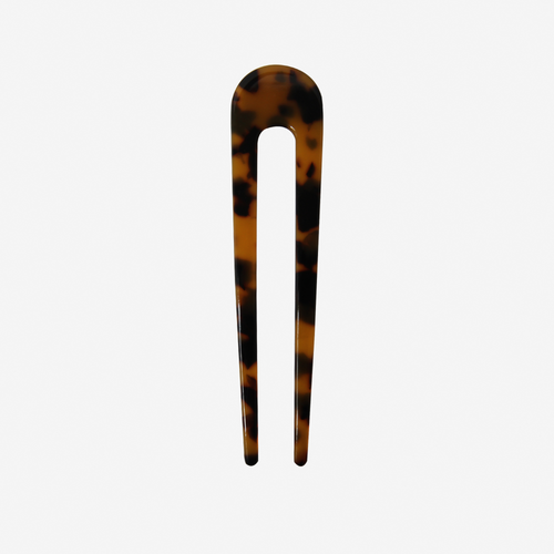 Dark Tortoiseshell French Hair Pin on an off white background
