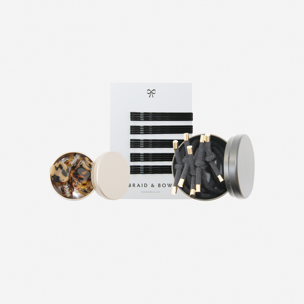 Curated hair accessory set including black and tortoiseshell hair slides, hair ties and hair claws, in keepsake tins and packaged in a beautiful gift box.
