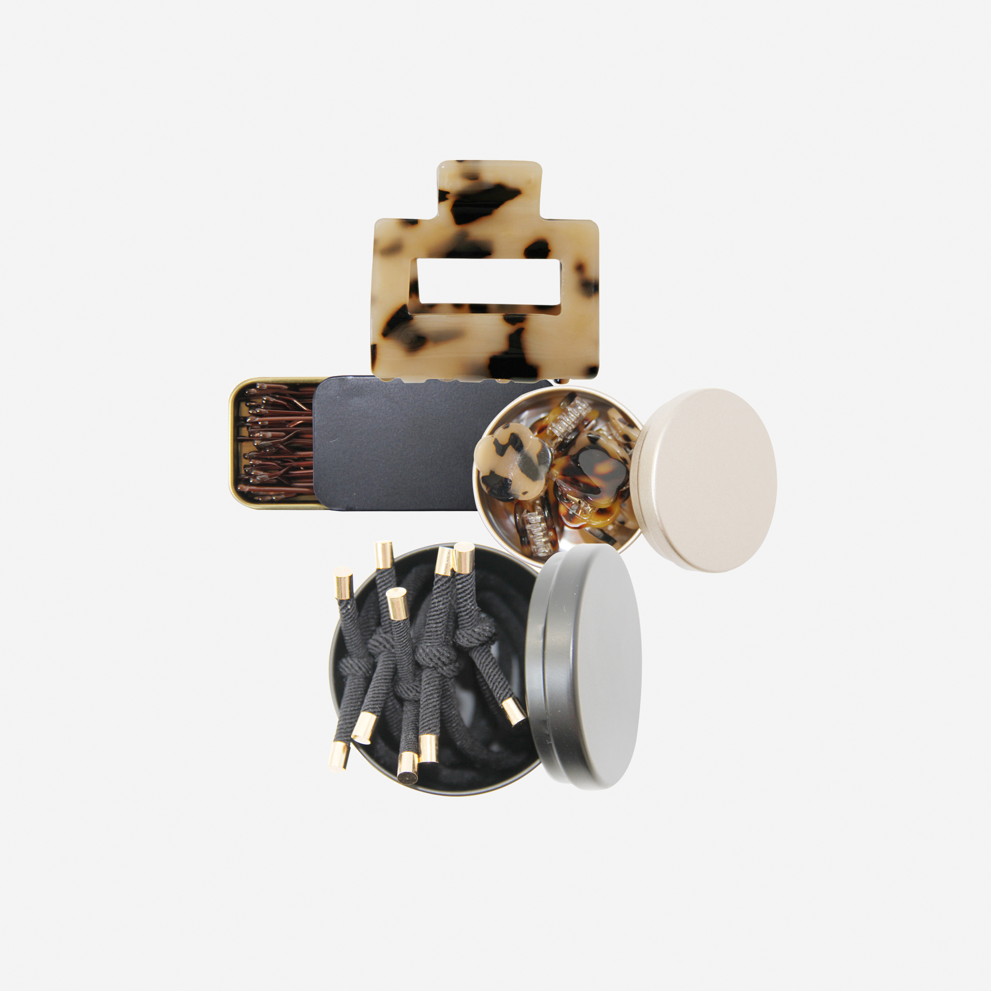 Curated hair accessory set including black and tortoiseshell hair slides, hair ties and hair claws, in keepsake tins and packaged in a beautiful gift box.