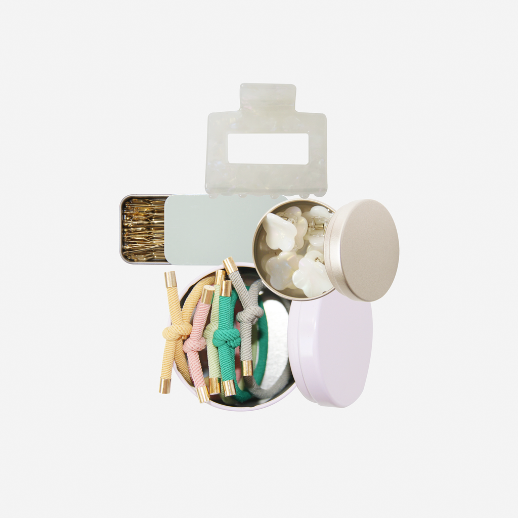 Curated pastel hair accessory gift set including mini hair claws, hair ties, kirby grips and a medium sized hair claw, in keepsake tins and packaged in a beautiful gift box.