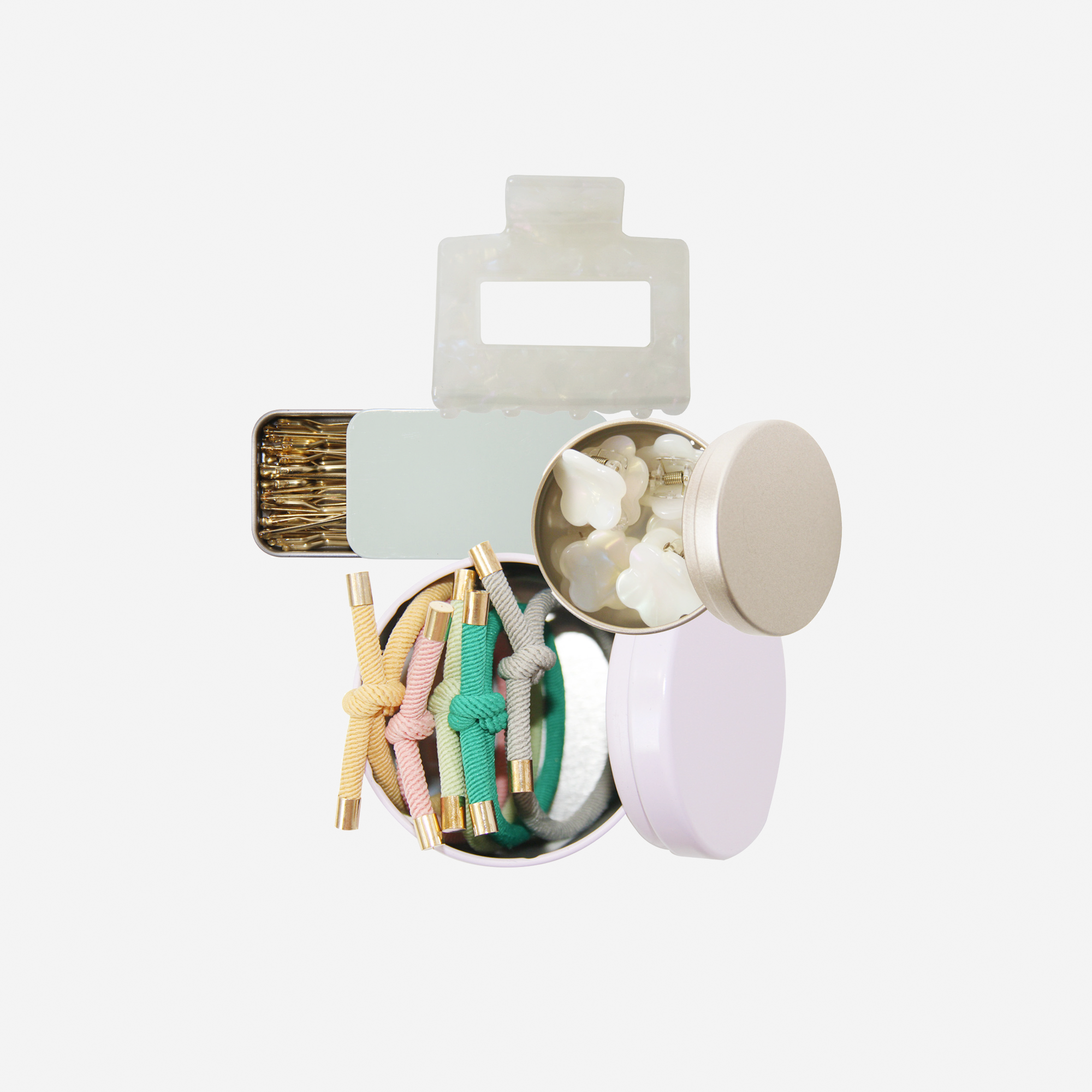 Curated pastel hair accessory gift set including mini hair claws, hair ties, kirby grips and a medium sized hair claw, in keepsake tins and packaged in a beautiful gift box.