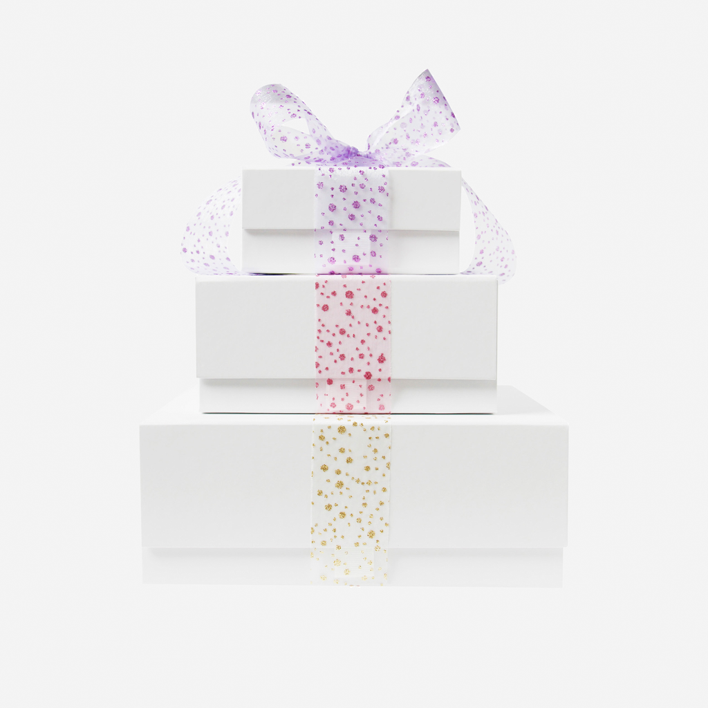 Stack of white gift boxes with solourful glitter organza ribbons fir Braid and Bow Gift Sets