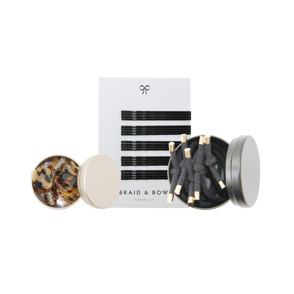 Set of hair accessories including hair ties, hair claws and set of black kirby grips on a white background