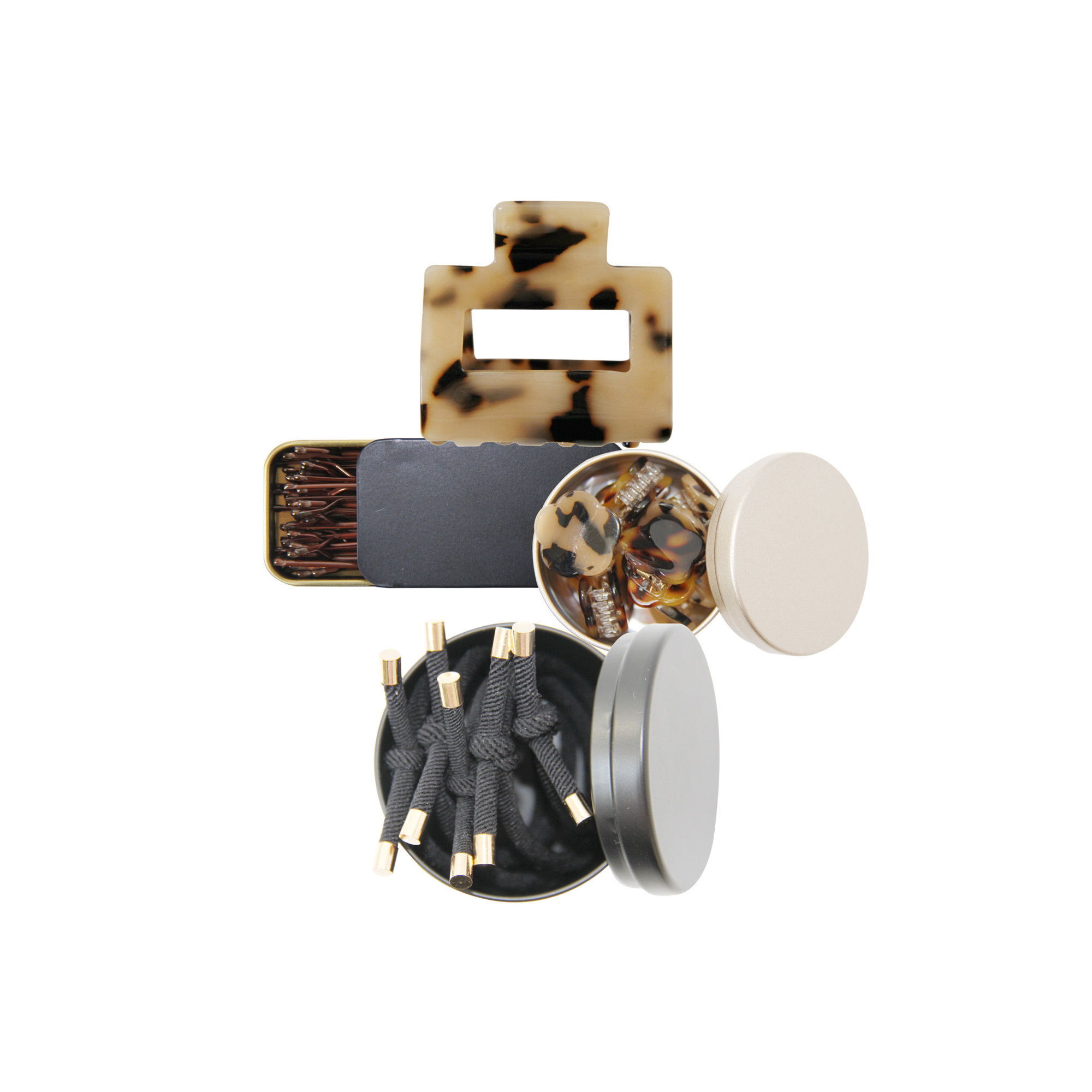 Set of hair accessories, showing hair ties, mini hair claws, kirby grips and a hair claw on a white background
