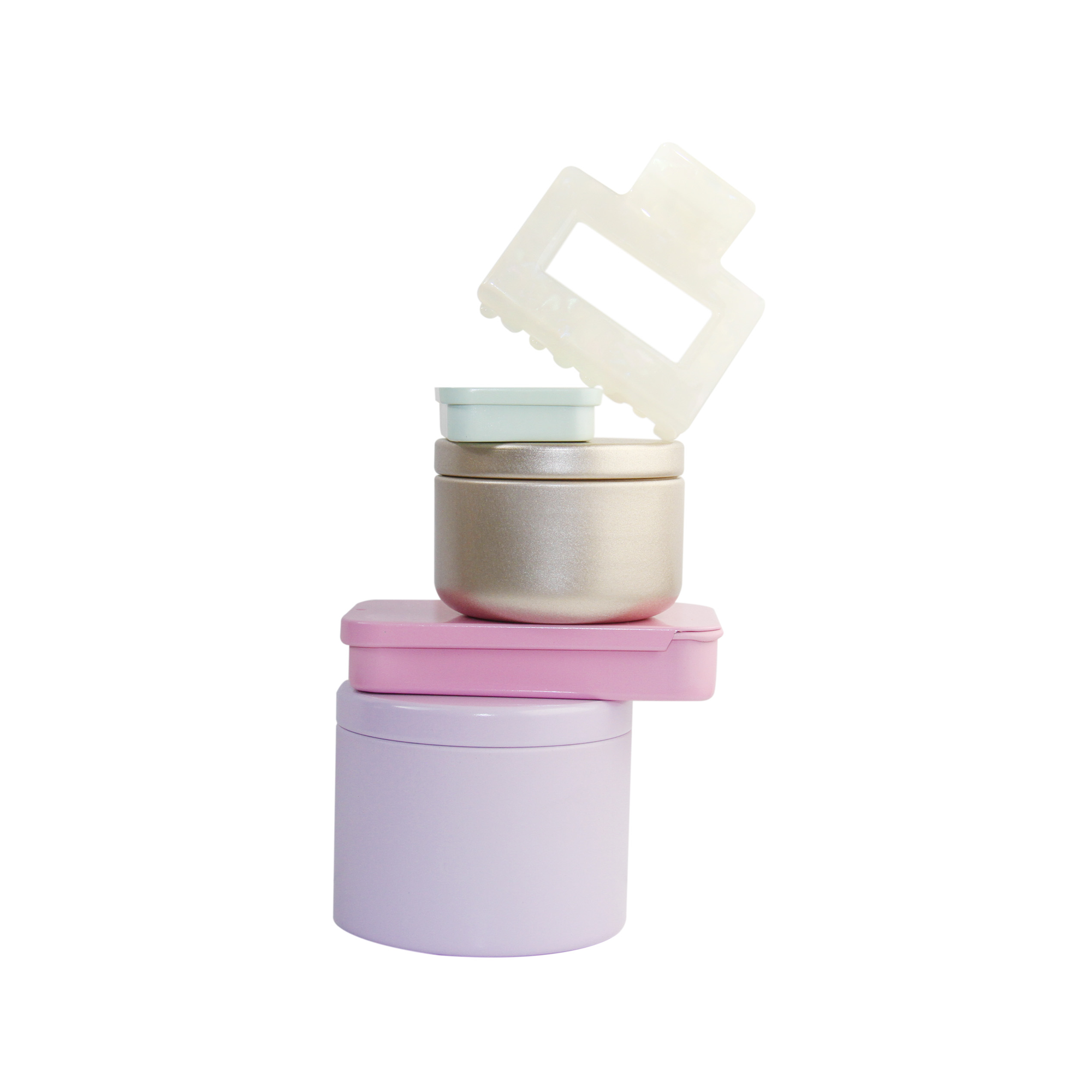 Braid & Bow gift set, stack of colourful tins containing hair claws, hair ties and kirby grips with a hair claw balanced on top, on a white background