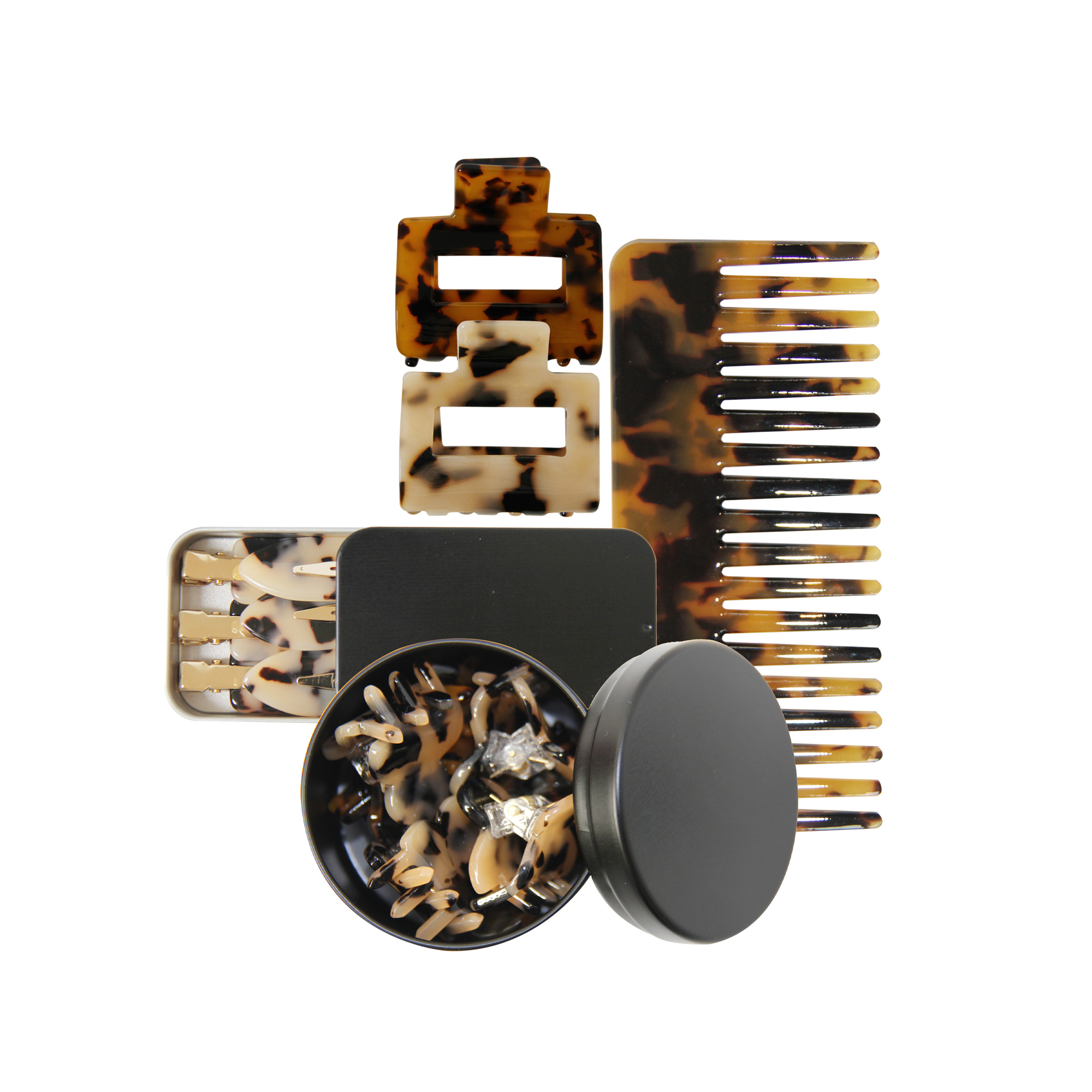 Set of tortoiseshell hair accessories including a comb and clips on a white background