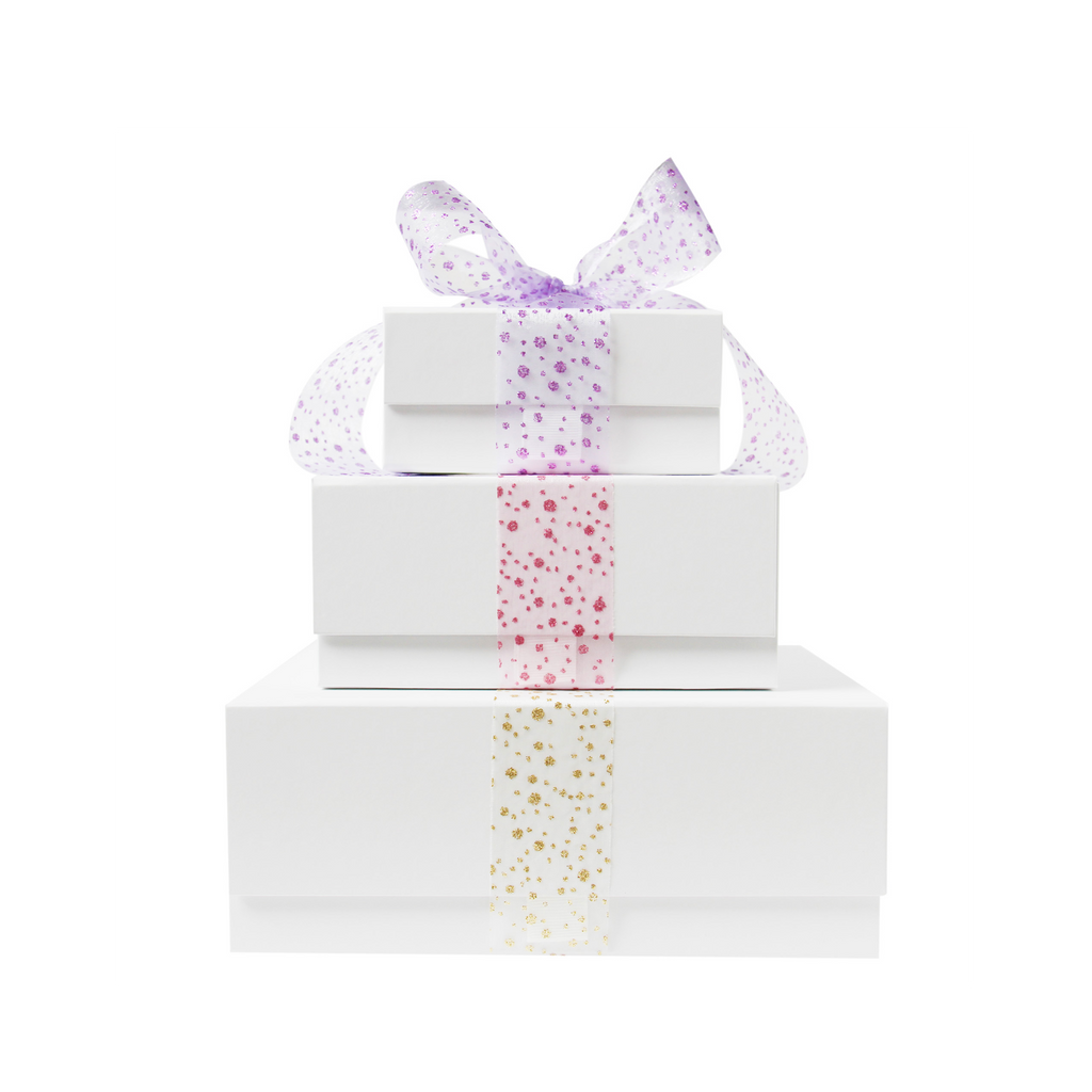 Stack of white gift boxes with decorative ribbons on a white background
