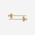 Set of two gold flower hair slides on an off white background