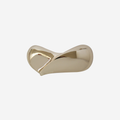 Gold teardrop hair clip on an off white background