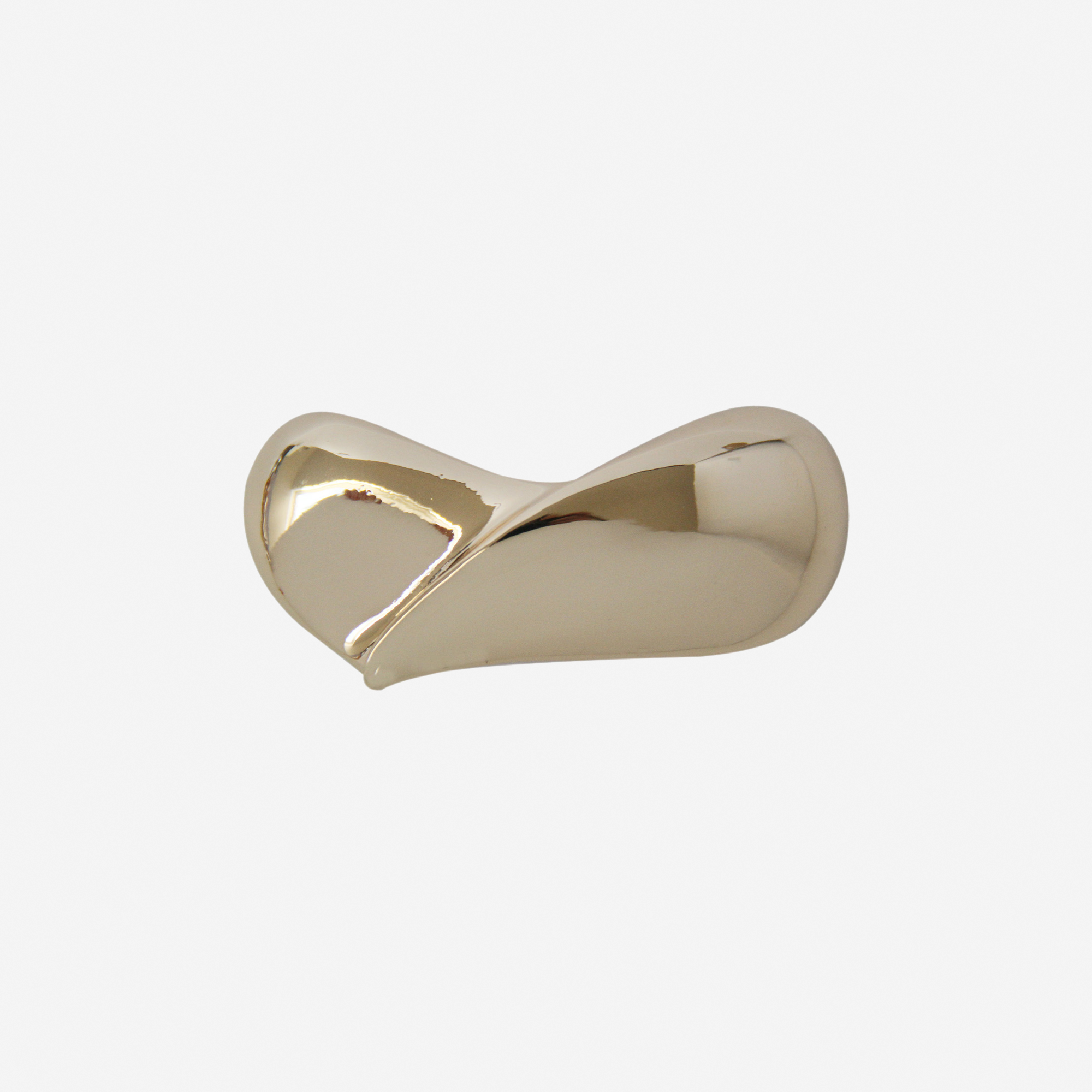 Gold teardrop hair clip on an off white background