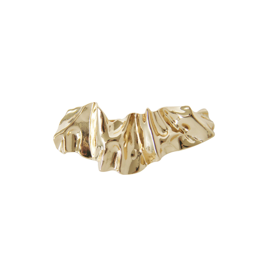 Gold creased hair clip on a white background
