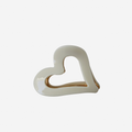 Cream heart shaped resin hair claw, on an off white background